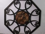 a metal wall decoration with a horse in the center