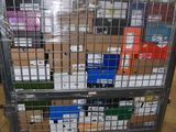 a metal cart with many boxes on it in a warehouse