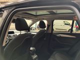 the interior of a car with the door open and the driver ' s seat down