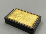 a gold and black box sitting on top of a table