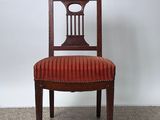a wooden chair with a red upholstered seat