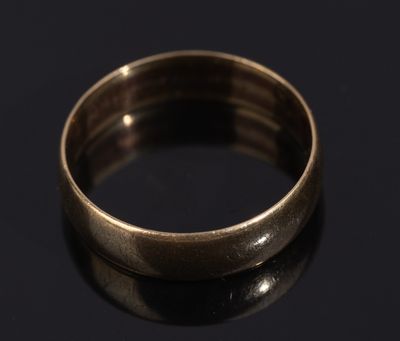 a close up of a gold ring on a black surface
