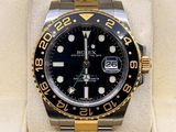 Montre Rolex avec cadran noir et lunette dorée