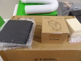 a cardboard box with a piece of black material on top of it