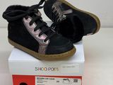 pair of black and pink shoes sitting on top of a white box