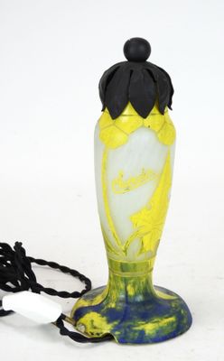 a yellow and blue vase with a black cord attached to it