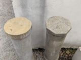two cement pillars sitting next to each other on the side of a building