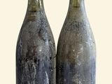 two bottles of wine sitting next to each other on a table
