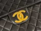 a close up of a chanel bag on a table