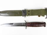 two knives that are laying side by side on a white surface