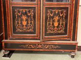 a cabinet that has been painted black and gold