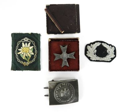 trois insignes et une boucle de ceinture sur un fond blanc