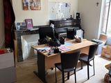 une photo d'un salon avec un piano et un bureau
