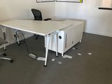 an image of an empty office with a desk and chairs