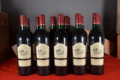 six bottles of red wine are lined up on a table