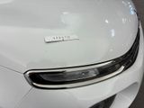 a close up of a white car that has a sticker on it