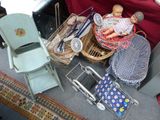 une poupée dans un panier posé à côté d'une chaise et d'autres objets