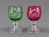 two wine glasses sitting next to each other on a table