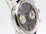 a close up of a wrist watch with a blue strap