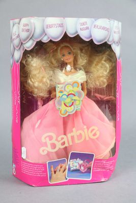 barbie doll in a pink dress with blonde hair in a pink box