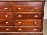 a wooden dresser with many drawers on top of it
