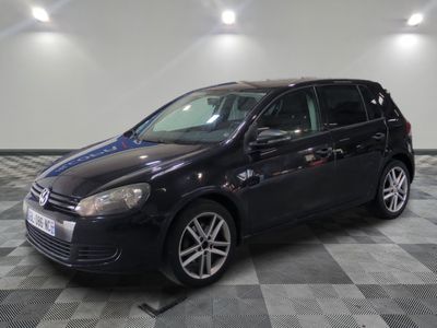 La Volkswagen Golf noire est garée dans une grande pièce.