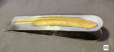 a silver and gold hair clip with a banana on it