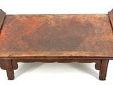 an old wooden table with a leather top on a white background
