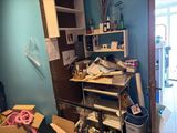 a room with a lot of clutter on the shelves
