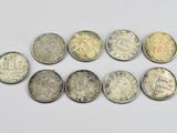a close up of a group of coins on a white surface