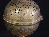 brass plate with a lid on a black background with a black background