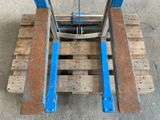 a wooden pallet with a blue handle on it