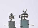 pair of antique coffee grinders on wooden bases on a white background