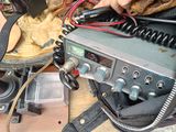 a person that is working on a radio on a table