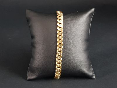 a black pillow with a gold chain on it