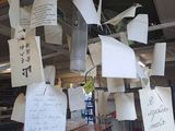 many pieces of paper hanging from the ceiling of a restaurant