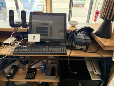 un ordinateur portable posé sur un bureau, avec un clavier et une souris