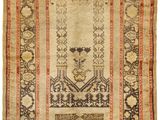 an antique rug with a floral design on a beige ground