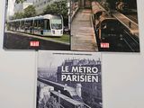 three books on a white table with a train on the cover