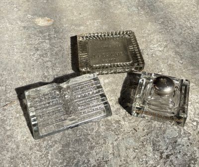 two ashtrays on the ground next to each other