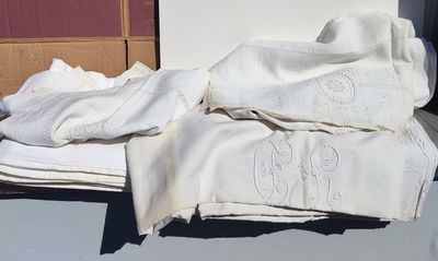 a pile of folded towels sitting on a window sill