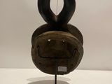 an image of a wooden sculpture with horns on a stand