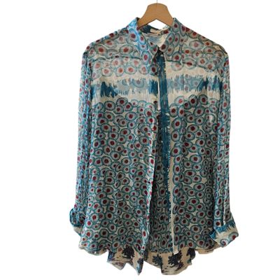 the shirt is blue and white with a pattern on it