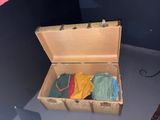 an open suitcase with clothes inside of it on the floor