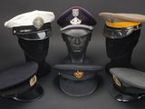 several hats are lined up in a row on a black surface