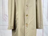 an image of a coat on a mannequin stand on a wooden floor