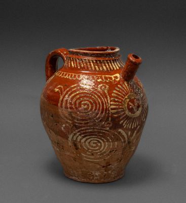 an image of a brown vase with designs on it