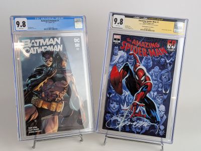 batman and spider - man comic books on display on a table