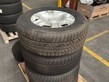 tires are stacked on pallets in a warehouse with pallets of other tires