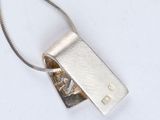 silver plated necklace with a rectangle shaped pendant on a silver chain